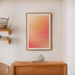 Oak-framed Good energy only gradient artwork displayed above a wooden console and ceramic vase