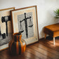 Oak-framed Sword & Scales artwork displayed in an interior setting.