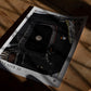 Unframed Artemis II Goodnight Moon art print lying on a wooden floor in dramatic window shadows.