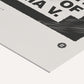 Close-up of a civil rights art print showing black hatched graphics, cropped lettering, and a small circular emblem on white paper.