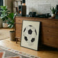 Black-framed 1930 World Cup opening match diagram artwork leaning against a wooden record console with turntable and speakers.