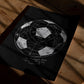 Unframed black soccer diagram art print resting on a sunlit wooden surface, with white handwritten text about the 1930 World Cup opening day.