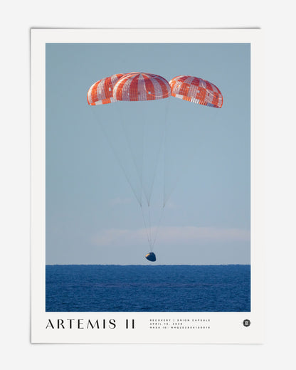 Unframed Artemis II art print showing the Orion capsule descending beneath three parachutes over the ocean.