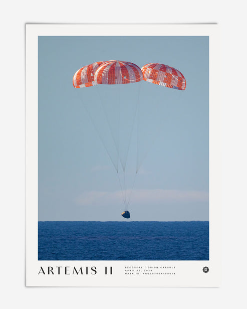 Unframed Artemis II art print showing the Orion capsule descending beneath three parachutes over the ocean.