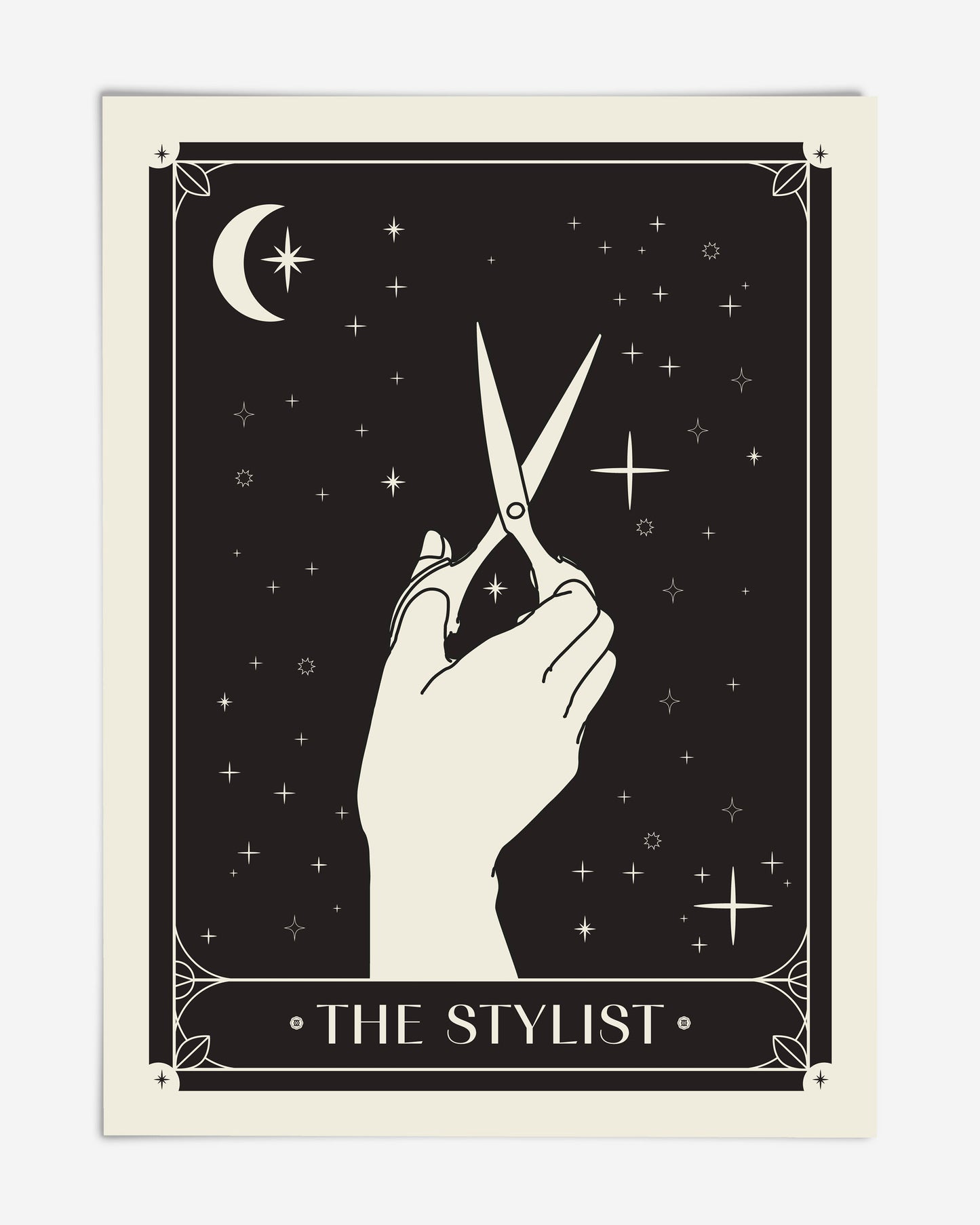 Unframed black-and-cream The Stylist art print featuring a hand holding scissors beneath a crescent moon and stars.